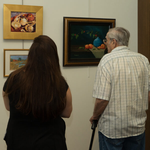 George Williams looking at paintings